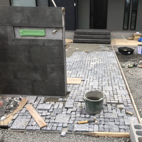 門袖タイル張りとアプローチのピエニーストーン張り作業となります。